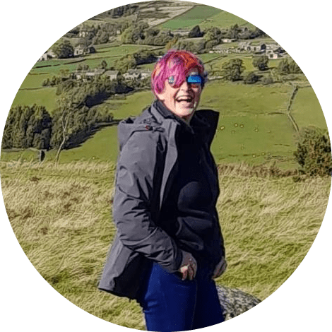 Photo of Olivia Butterworth standing outside with fields in the background.
